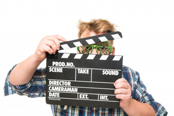 man holding clapperboard video editing software